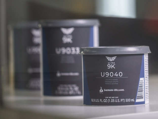 Professional painter applying Sherwin-Williams water-based paint on a modern interior wall, clean finish, high quality, bright natural lighting, realistic style